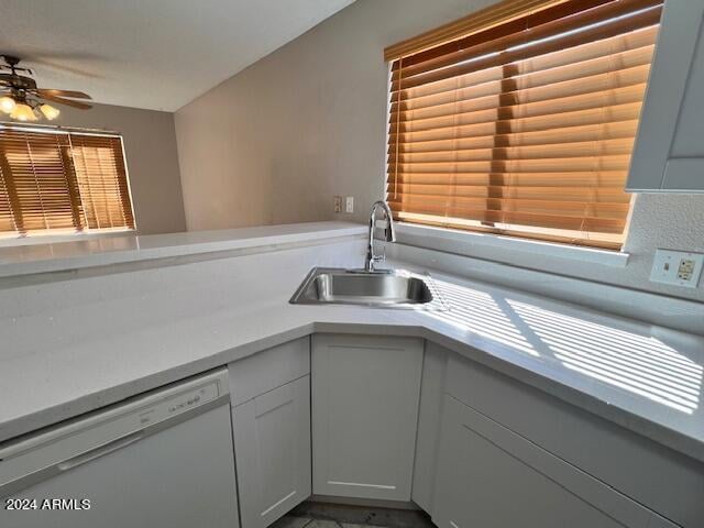 kitchen with white cabinets, dishwasher, ceiling fan, and sink