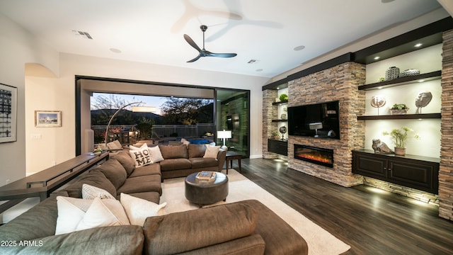 122 E Desert Wind Dr, Phoenix, AZ 85048 - living area featuring a glass covered fireplace, visible vents, ceiling fan, and wood finished floors
