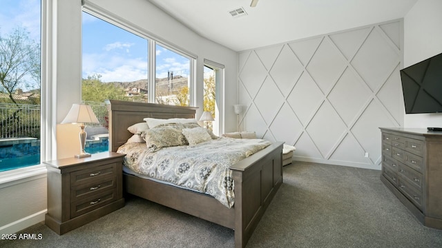 122 E Desert Wind Dr, Phoenix, AZ 85048 - carpeted bedroom with visible vents, a decorative wall, and baseboards