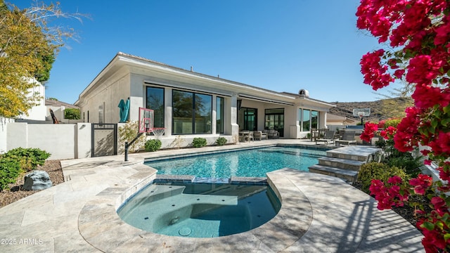 122 E Desert Wind Dr, Phoenix, AZ 85048 - view of pool with a pool with connected hot tub, fence, and a patio