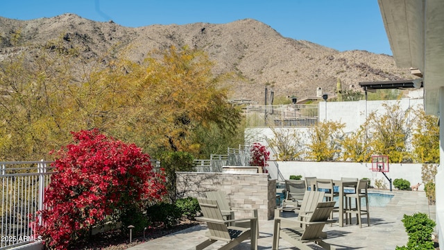 122 E Desert Wind Dr, Phoenix, AZ 85048 - view of patio / terrace with fence, a mountain view, and outdoor dining area