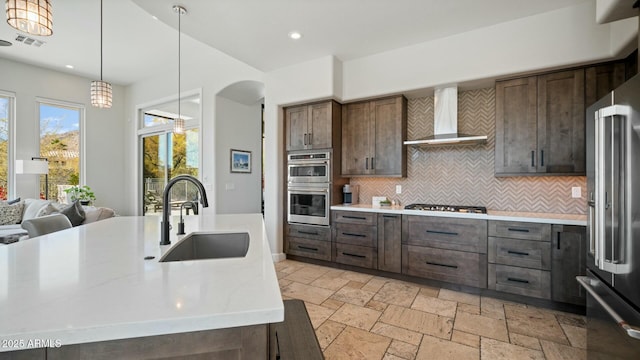 122 E Desert Wind Dr, Phoenix, AZ 85048 - kitchen featuring stone tile flooring, visible vents, appliances with stainless steel finishes, a sink, and wall chimney exhaust hood