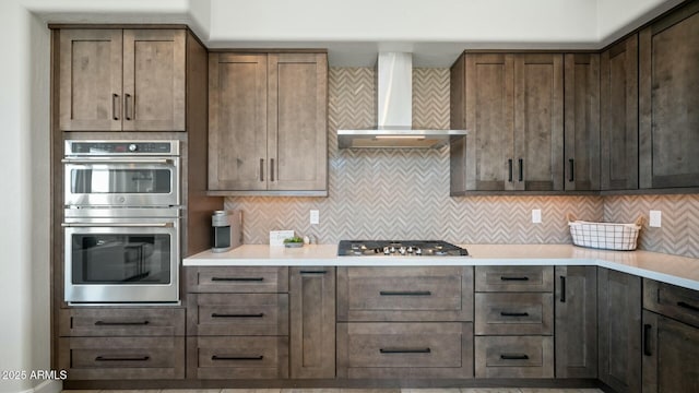 122 E Desert Wind Dr, Phoenix, AZ 85048 - kitchen with appliances with stainless steel finishes, light countertops, wall chimney exhaust hood, and tasteful backsplash