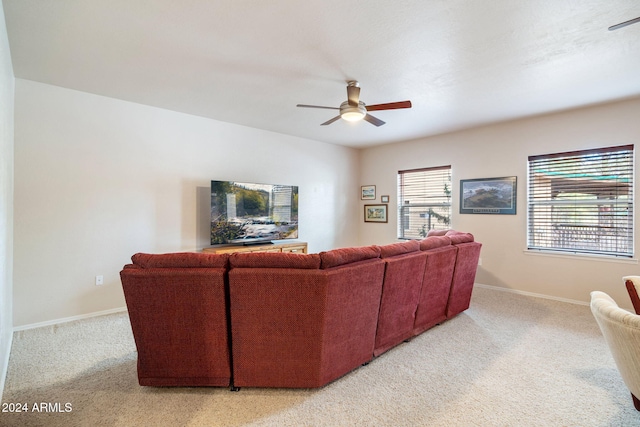 living room with light colored carpet and ceiling fan