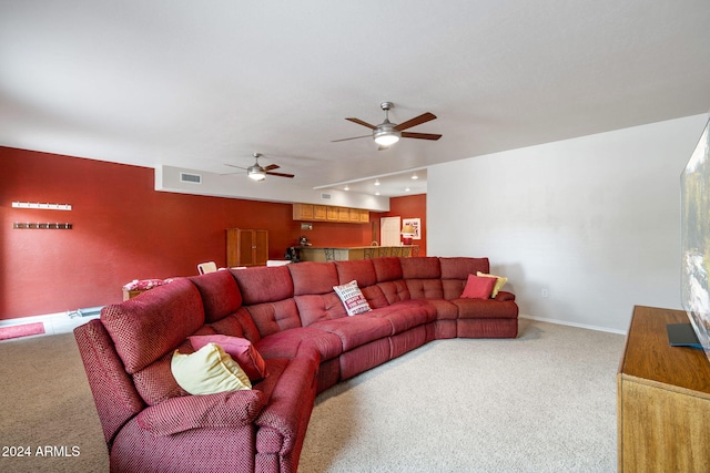 carpeted living room with ceiling fan