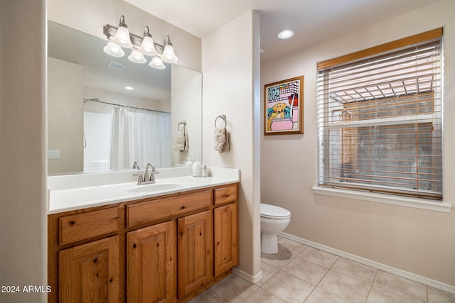 bathroom featuring tile patterned floors, vanity, and toilet