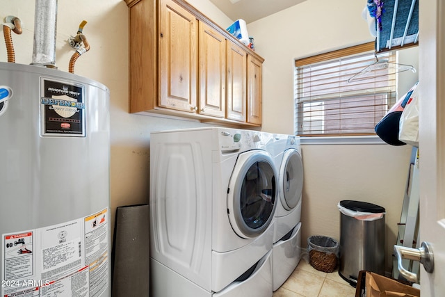 laundry room with light tile patterned floors, cabinets, gas water heater, and independent washer and dryer