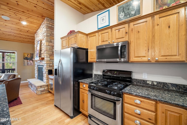 kitchen with wooden ceiling, light hardwood / wood-style flooring, dark stone counters, and appliances with stainless steel finishes