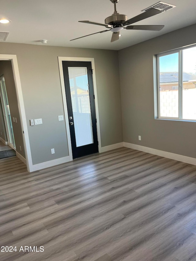 spare room featuring hardwood / wood-style floors and ceiling fan