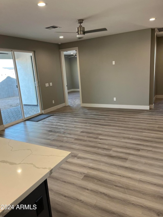 unfurnished room featuring ceiling fan and light hardwood / wood-style flooring