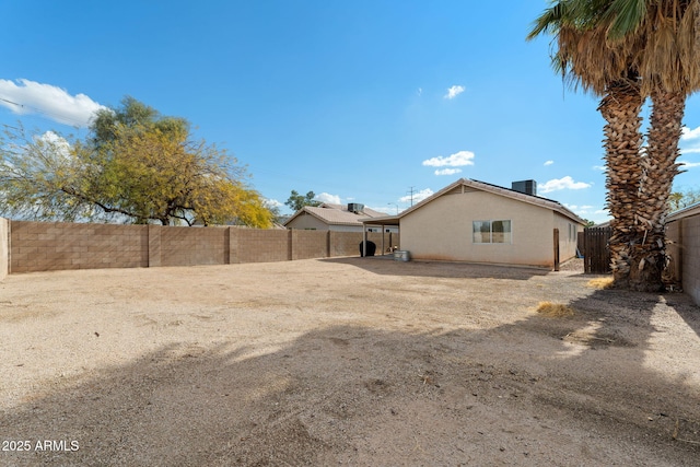 back of house with central AC unit