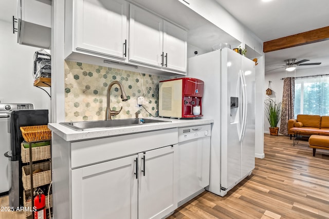 8116 N 55th Dr, Glendale, AZ 85302 - kitchen featuring white appliances, light countertops, tasteful backsplash, light wood-type flooring, and beamed ceiling