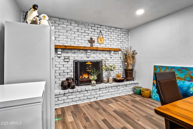 8116 N 55th Dr, Glendale, AZ 85302 - living area featuring wood finished floors and a brick fireplace