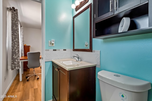 8116 N 55th Dr, Glendale, AZ 85302 - bathroom with vanity, wood finished floors, and decorative backsplash