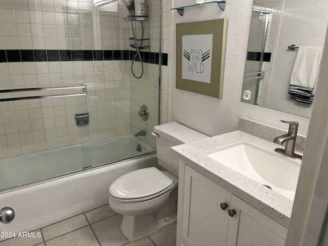 full bathroom with tile patterned floors, vanity, enclosed tub / shower combo, and toilet