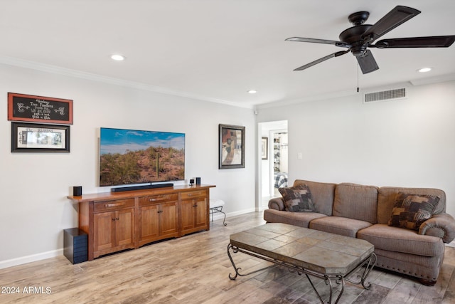 living room with ceiling fan, crown molding, and light hardwood / wood-style flooring