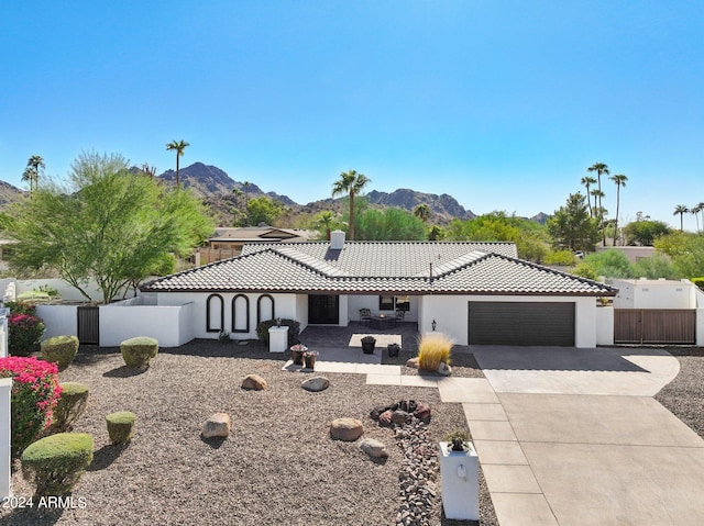 view of front facade featuring a mountain view and a garage