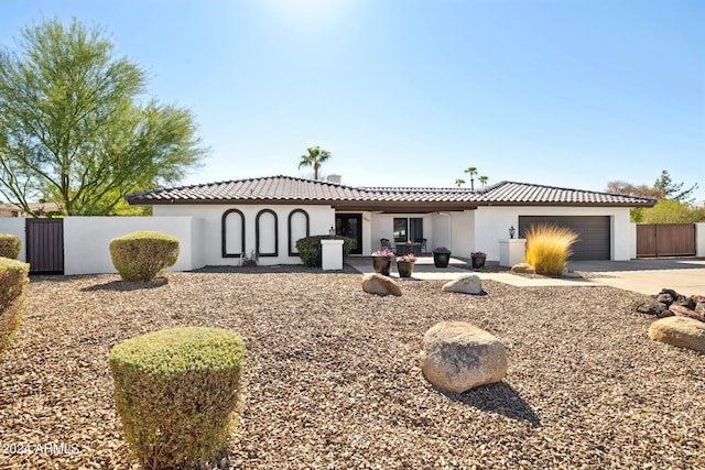 mediterranean / spanish home featuring a garage