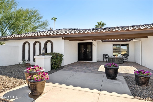 exterior space with outdoor lounge area, french doors, and a patio area