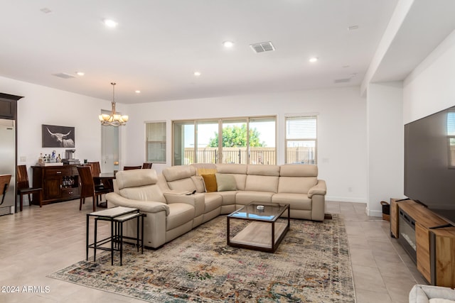 living room featuring a notable chandelier and light tile flooring