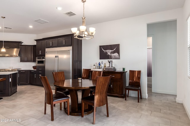 tiled dining area featuring an inviting chandelier