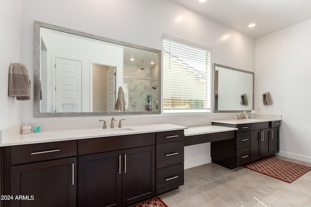 bathroom featuring a tile shower, tile flooring, and double sink vanity