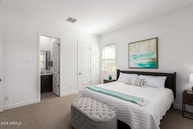 carpeted bedroom featuring connected bathroom