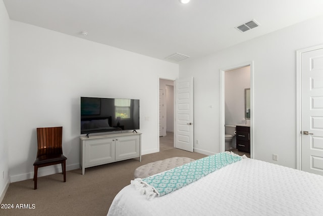 bedroom featuring light carpet and ensuite bathroom