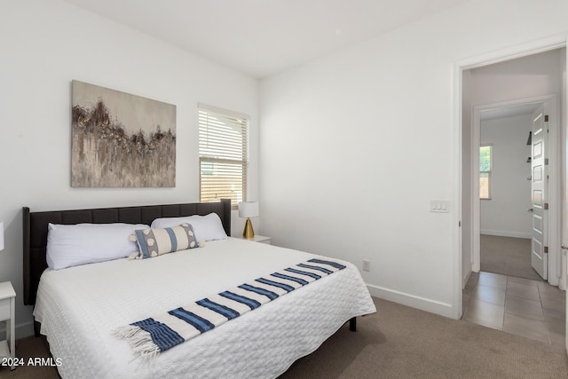 tiled bedroom with multiple windows