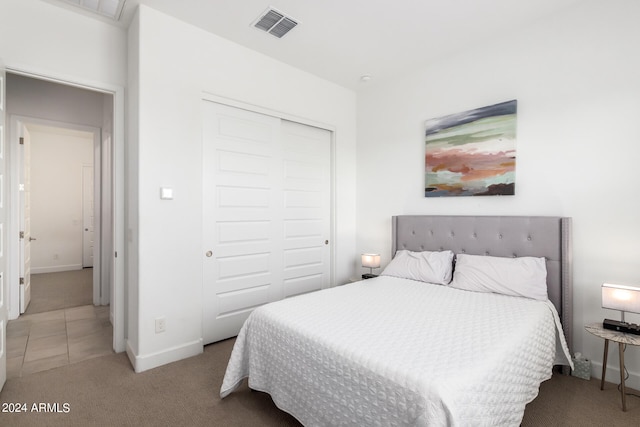 tiled bedroom with a closet