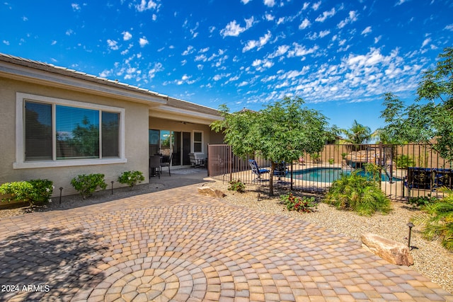 view of patio / terrace with a fenced in pool