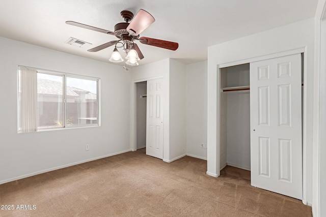 11139 W Devonshire Ave, Phoenix, AZ 85037 - unfurnished bedroom with carpet floors, multiple closets, baseboards, and a ceiling fan