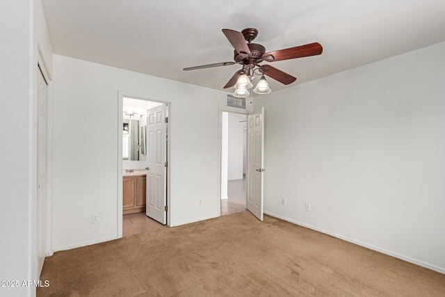 11139 W Devonshire Ave, Phoenix, AZ 85037 - unfurnished bedroom with light colored carpet, ensuite bathroom, baseboards, a closet, and a ceiling fan