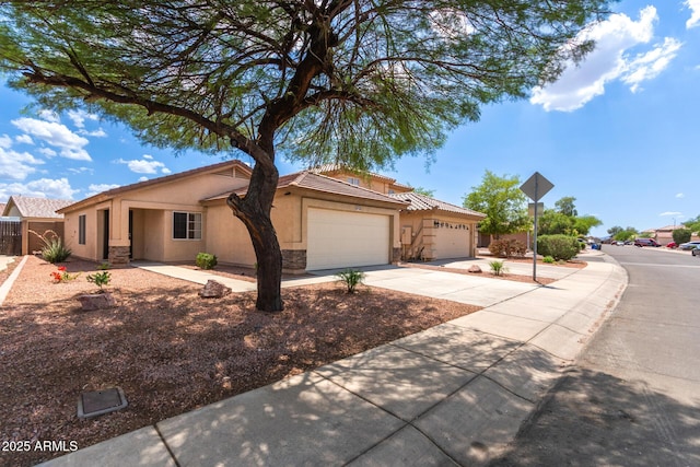 11139 W Devonshire Ave, Phoenix, AZ 85037 - view of front of property with stucco siding, an attached garage, stone siding, driveway, and a tile roof