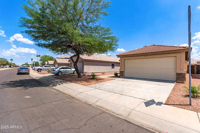 11139 W Devonshire Ave, Phoenix, AZ 85037 - view of front facade featuring stucco siding, a tile roof, concrete driveway, and a garage