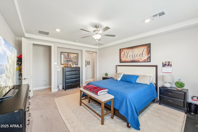 bedroom featuring a tray ceiling, carpet flooring, recessed lighting, and visible vents