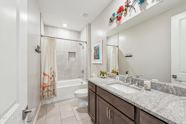 bathroom featuring vanity, visible vents, shower / tub combo, tile patterned floors, and toilet