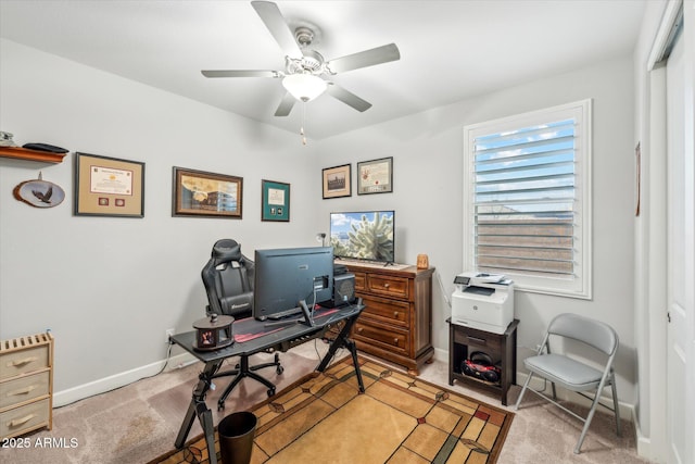 office area with baseboards, light colored carpet, and a ceiling fan