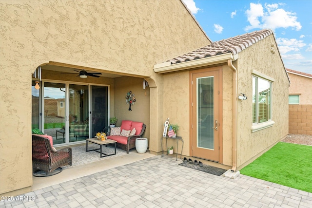 view of patio with a ceiling fan and fence