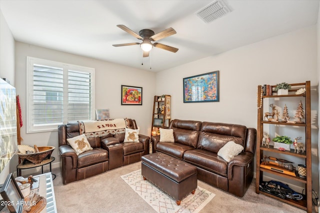 carpeted living area featuring visible vents and ceiling fan