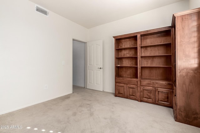 unfurnished bedroom with visible vents and light colored carpet