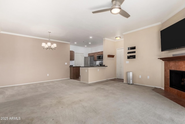 unfurnished living room with light carpet, ornamental molding, ceiling fan with notable chandelier, and a tile fireplace