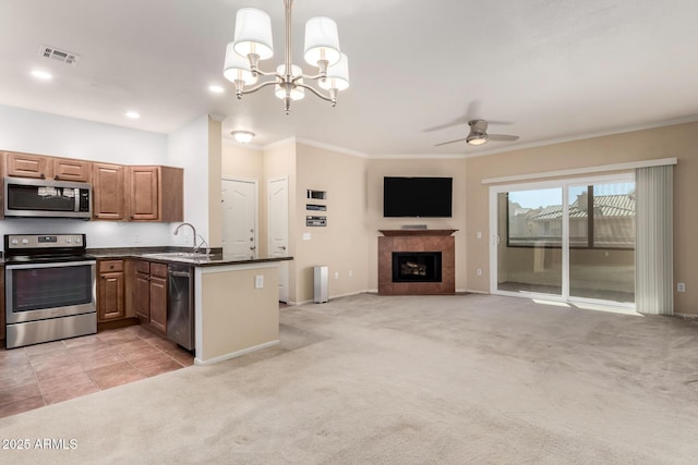 kitchen with light carpet, dark countertops, visible vents, and stainless steel appliances