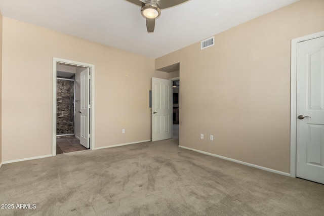 unfurnished bedroom with baseboards, visible vents, connected bathroom, ceiling fan, and carpet floors