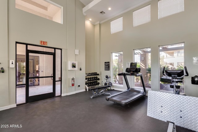 exercise room with ornamental molding, recessed lighting, visible vents, and baseboards