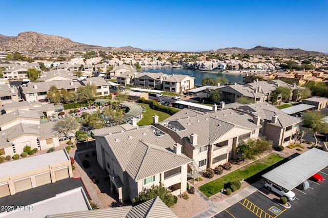 birds eye view of property featuring a water and mountain view and a residential view