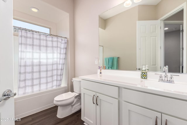 bathroom featuring wood finished floors, toilet, vanity, and shower / bath combination with curtain