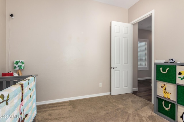 bedroom with carpet floors and baseboards