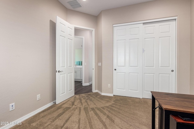 unfurnished bedroom featuring carpet flooring, a closet, and baseboards