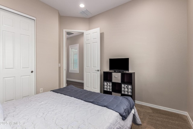 carpeted bedroom featuring baseboards and a closet